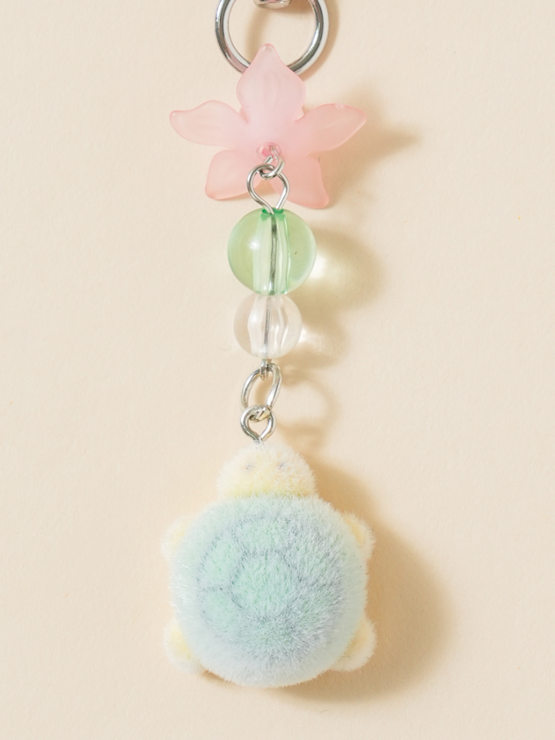 Turtle-shaped keychain with a traditional aesthetic design.