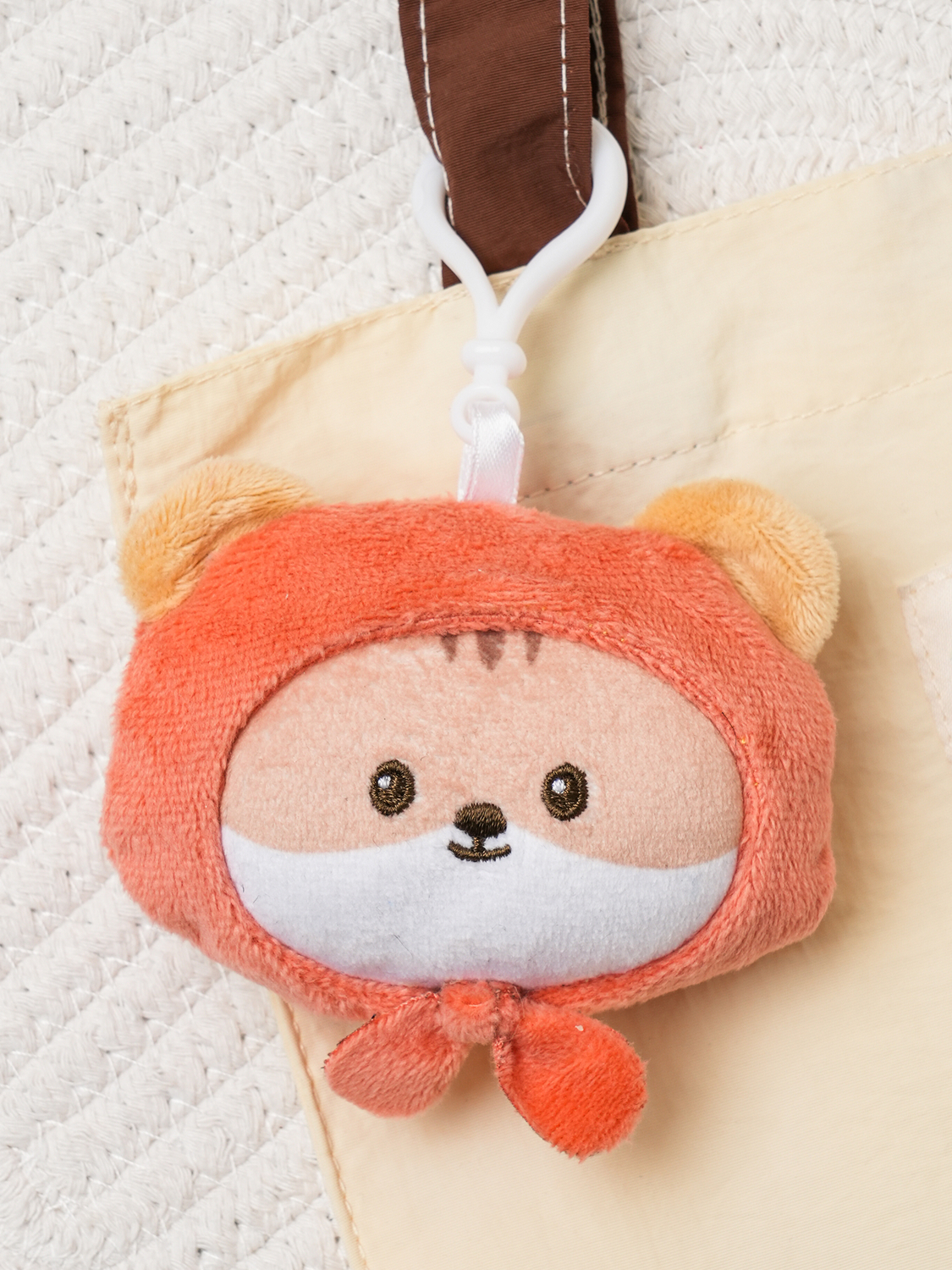A cute squirrel figurine wearing a fall-themed costume.